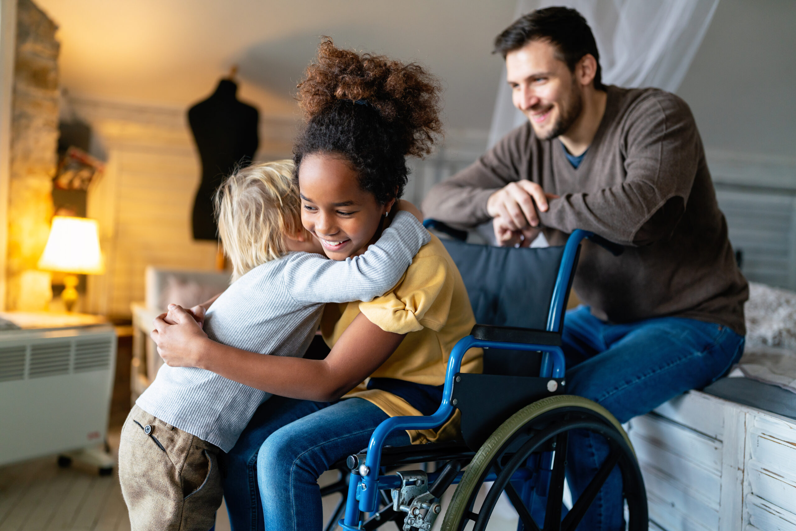 Happy multiethnic loving family. Smiling little girl with disability in wheelchair